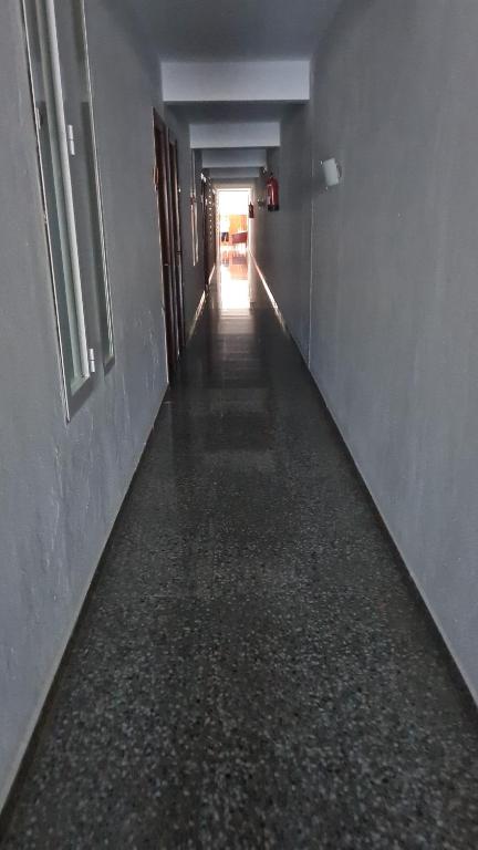 an empty hallway with a long long corridor at Hostal S'Algaret in Fornells