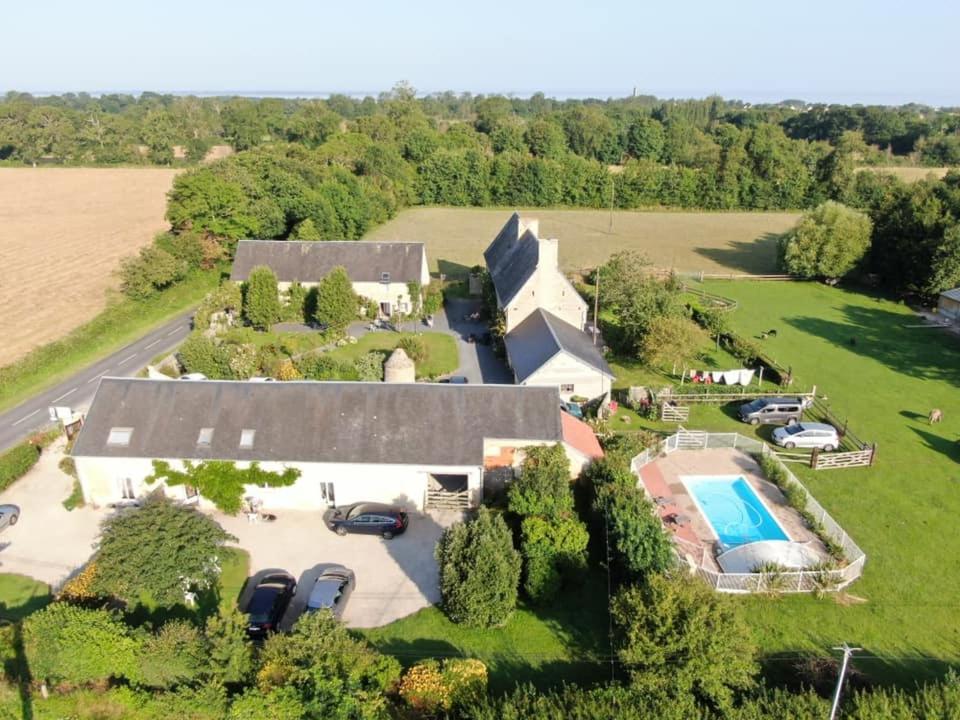 an aerial view of a house with a swimming pool at Gites Les Pieris in Grandcamp-Maisy