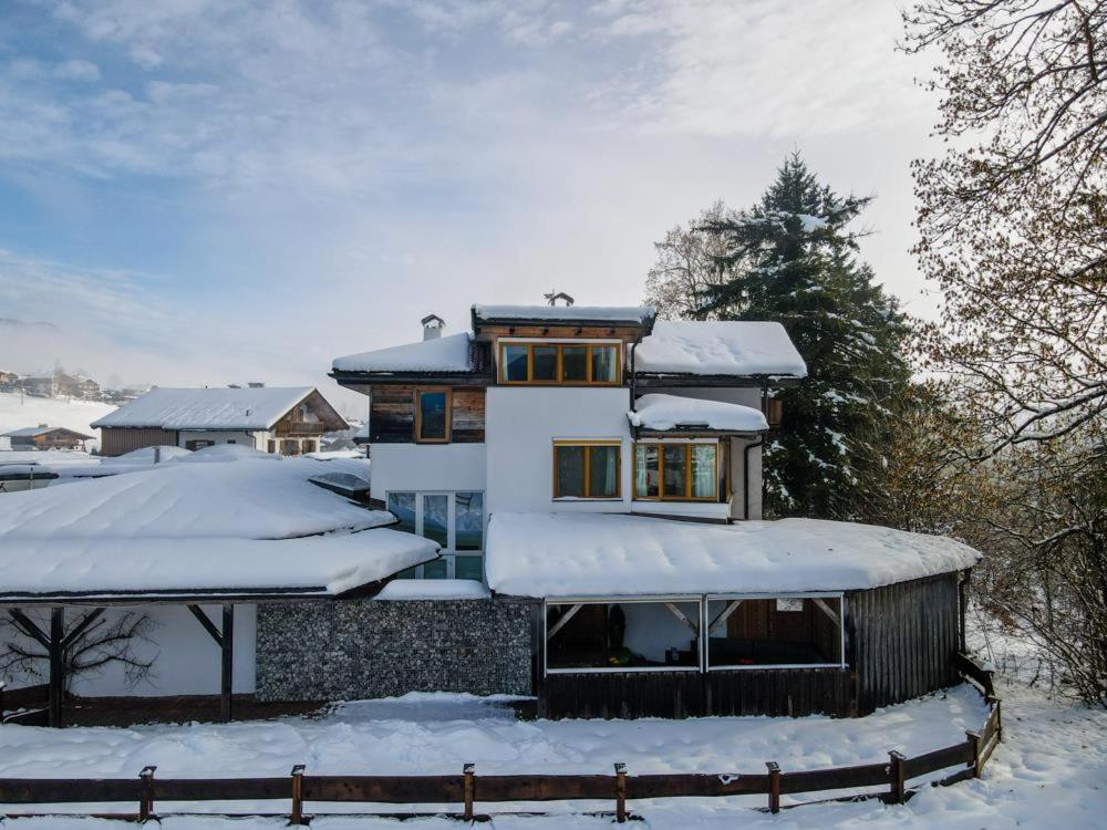 a house in the snow with snow covered roofs at Ferienhaus Pletzer in Going