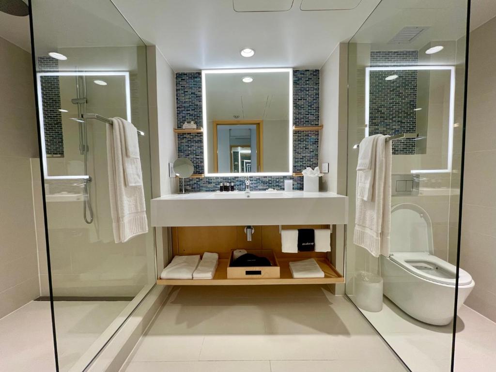 a bathroom with a sink and a toilet at The Morgan Resort Spa & Village in Simpson Bay