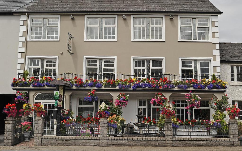 a building with flower boxes on the front of it at Clooneen House in Westport