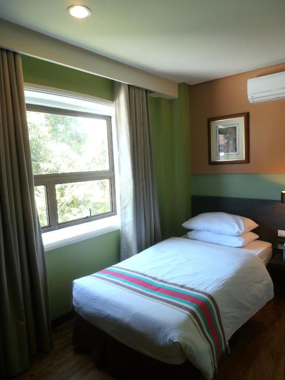 Postel nebo postele na pokoji v ubytování Ciudad Fernandina Hotel