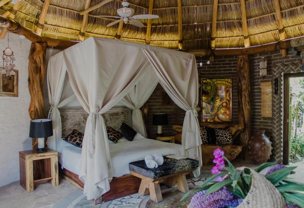 a bedroom with a bed with a canopy at Mandala Thai in Ajijic