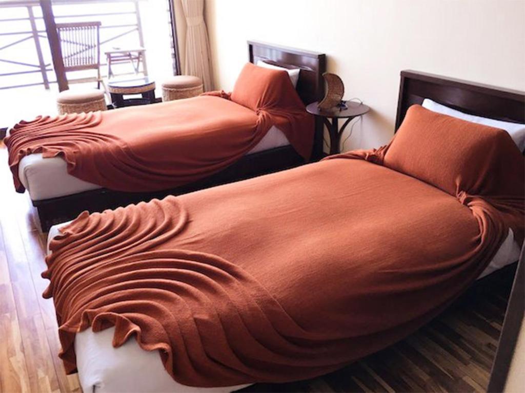 Ένα ή περισσότερα κρεβάτια σε δωμάτιο στο KAYA RESORT KOURIJIMA - Vacation STAY 95301v