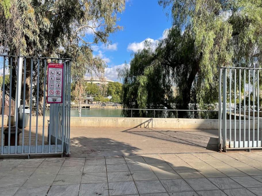 a gate with a sign in front of a park at Selva La Bella. En el Corazón de Triana in Seville