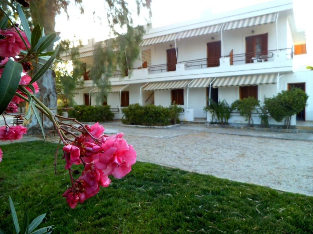 a building with pink flowers in front of it at Poseidon Apartments in Gythio