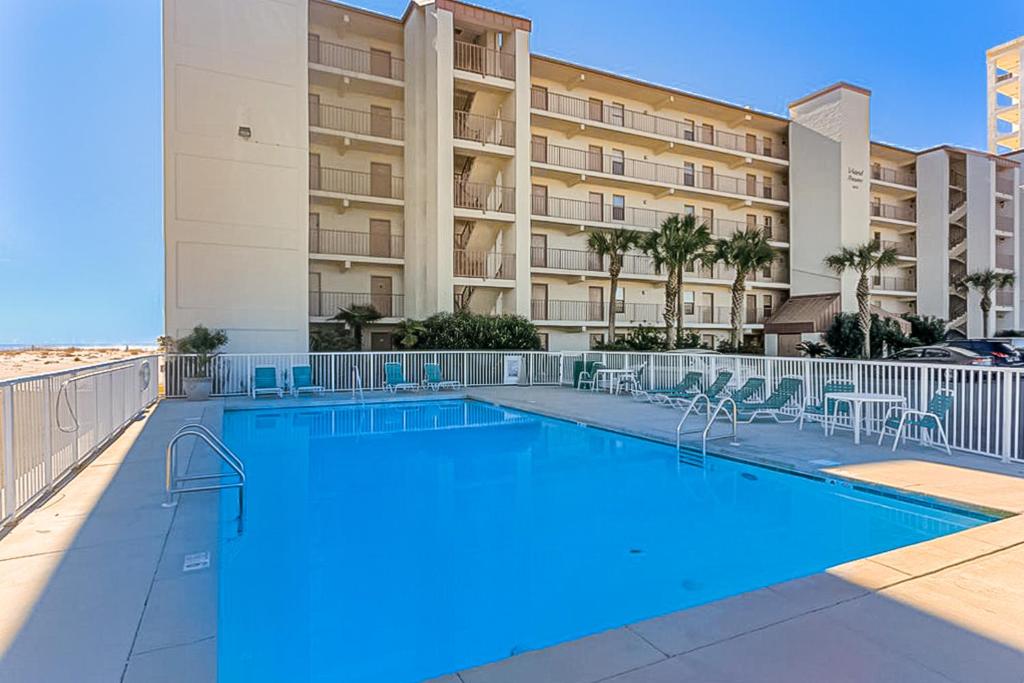a swimming pool in front of a building at Island Shores Condos II in Gulf Shores