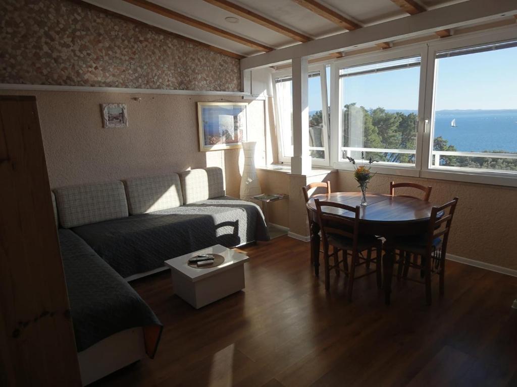 a living room with a couch and a table at Apartments Maria - close to the beach in Split