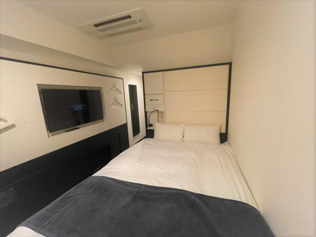 Postel nebo postele na pokoji v ubytování HOTEL SUI KANDA by ABEST