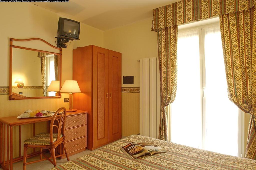 Posteľ alebo postele v izbe v ubytovaní Hotel Casella