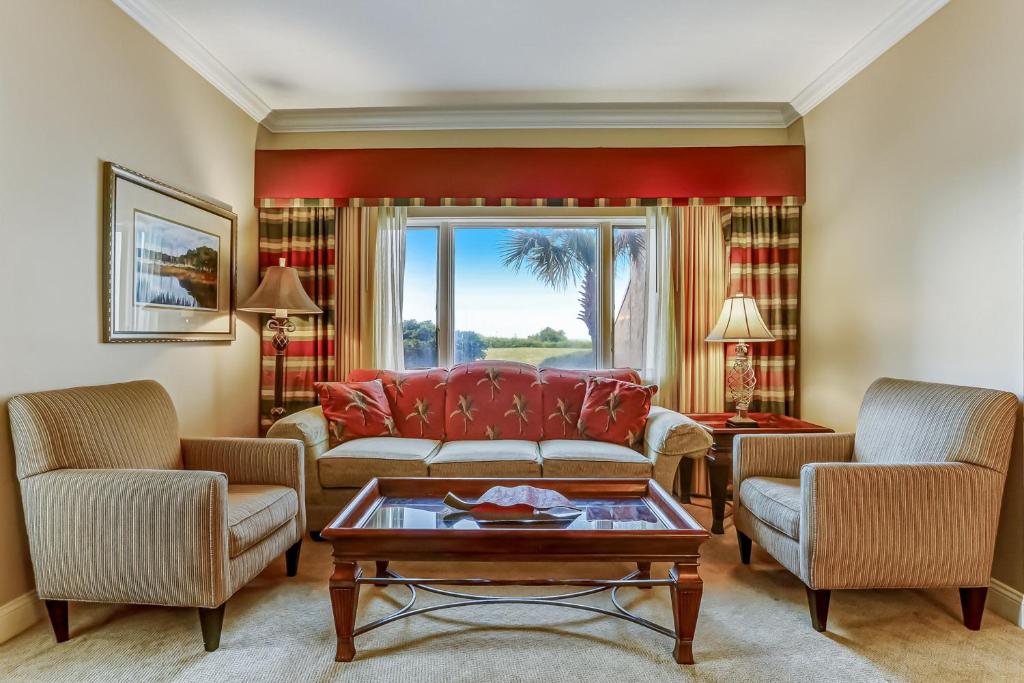 a living room with a couch and two chairs at 255-56 Sandcastles in Fernandina Beach