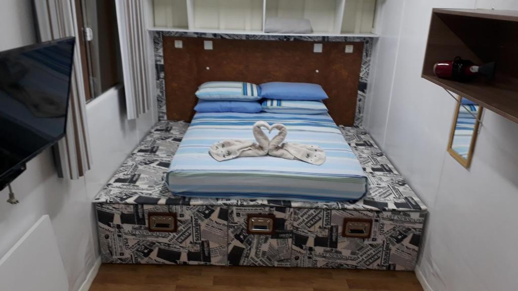 Postel nebo postele na pokoji v ubytování Kitinet Container próximo Praia e Beto Carrero