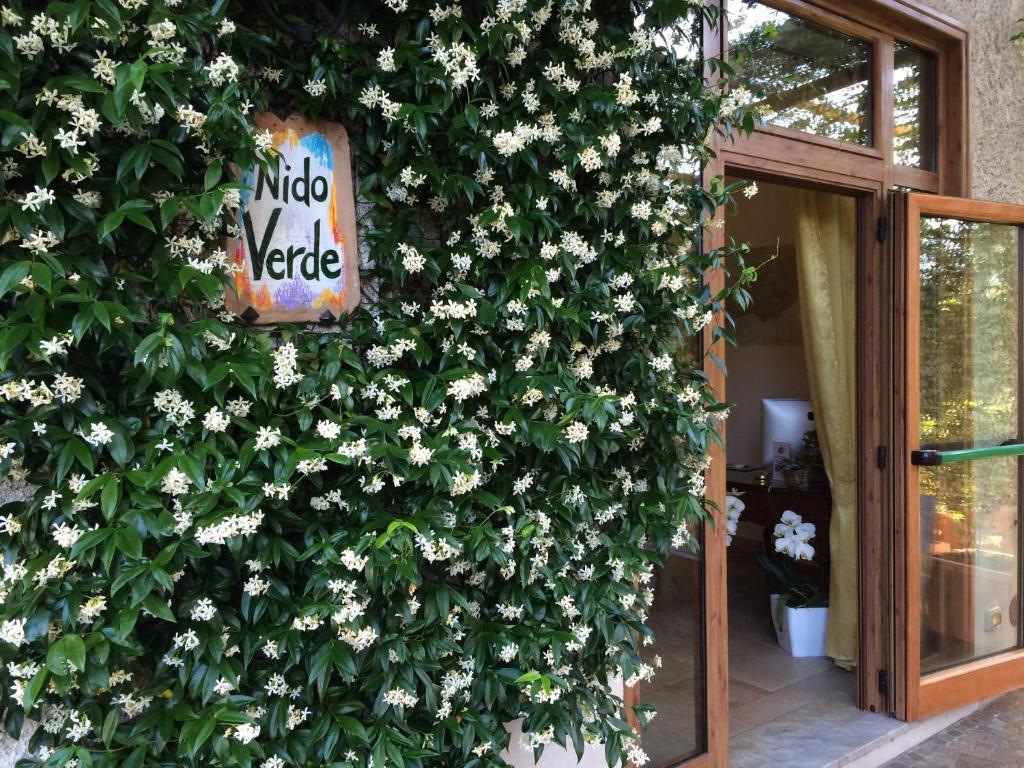 
a white door with flowers in front of a window at Nido Verde in Agerola
