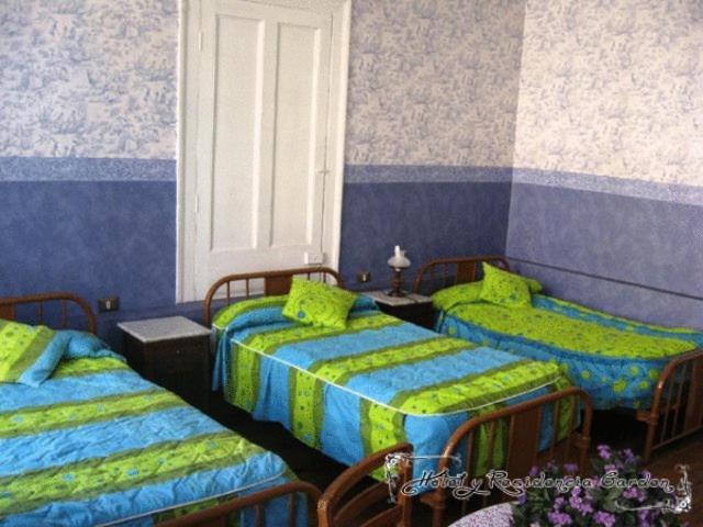 Postel nebo postele na pokoji v ubytování Hotel Garden