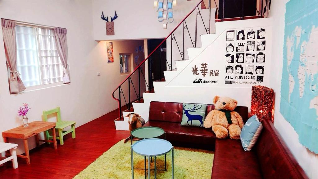 a teddy bear sitting on a couch in a living room at 光華民宿 in Chaozhou
