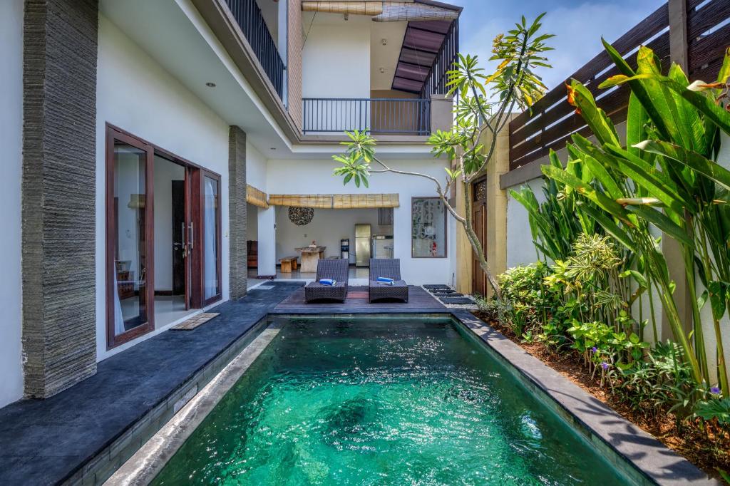 a swimming pool in the backyard of a villa at Villa Raka in Legian