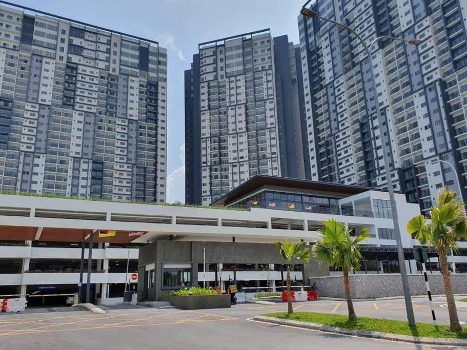 a gas station in front of tall buildings at MEDINA's 5STAR CondoSTAY in Nilai in Nilai