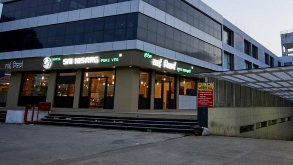 a store front of a building with a lot of windows at HOTEL SAI NISARG in Shirdi