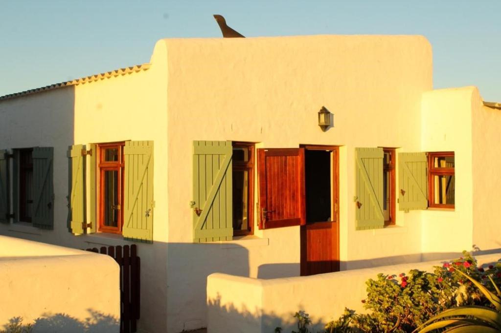 a building with colorful doors and windows on it at C-Breeze in Paternoster