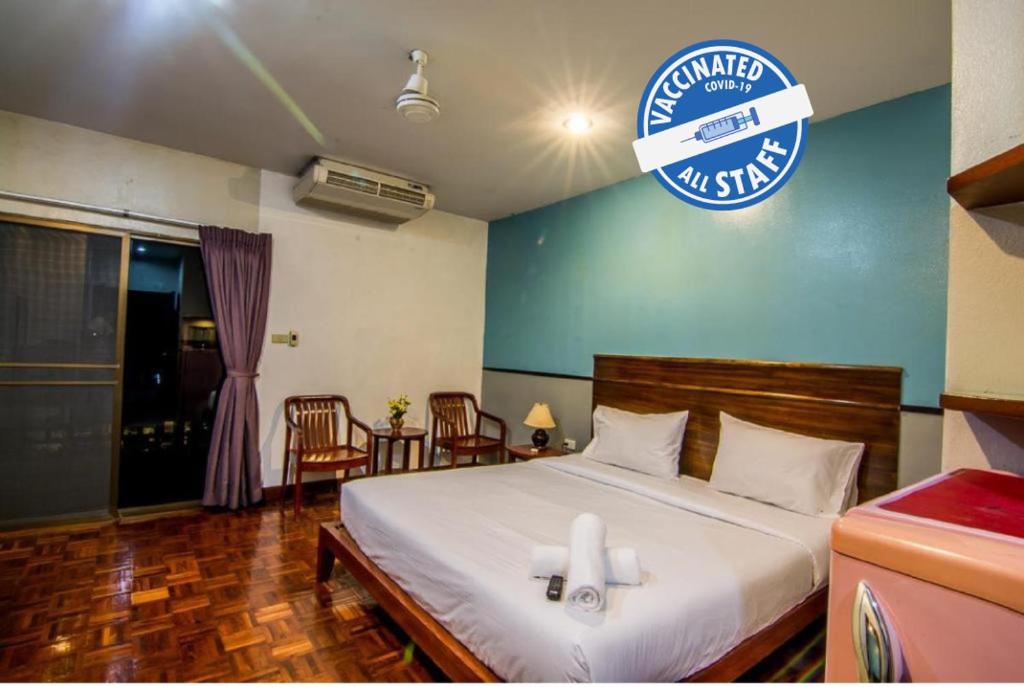a bedroom with a bed with a sign on the wall at Sutus Court 4 in Pattaya