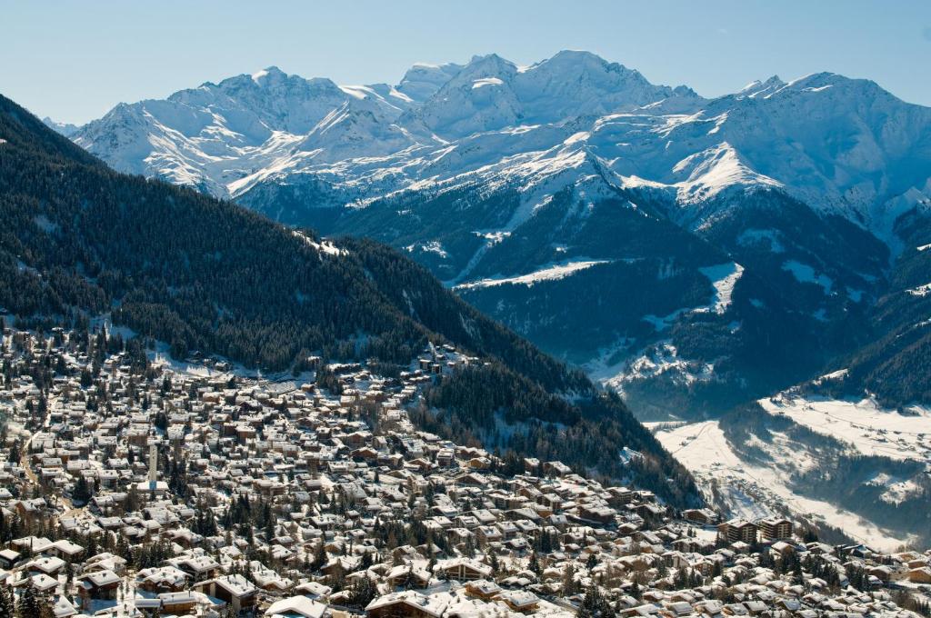 an aerial view of a city with snow covered mountains at Hotel Montpelier in Verbier