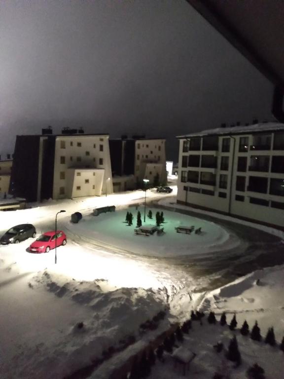 a group of people standing on top of a building in the snow at Apartment NM Bjelašnica in Bjelašnica