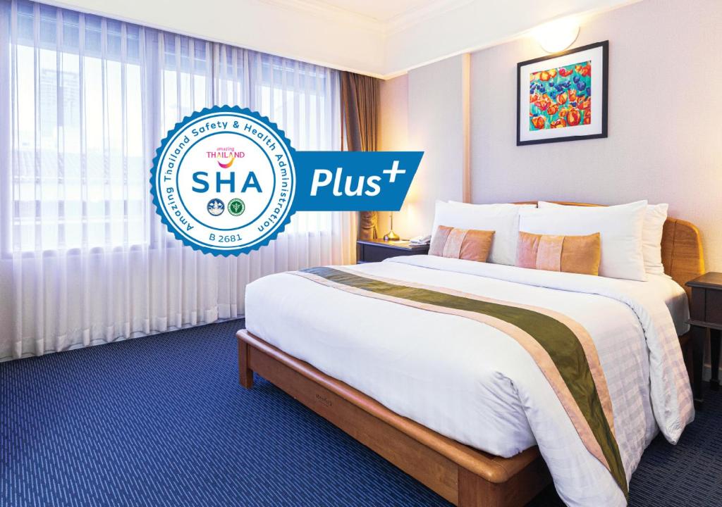 a hotel room with a bed and a sign that says sha plus at Le Siam Hotel by PCL in Bangkok