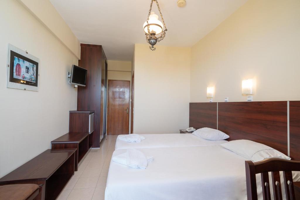 Postel nebo postele na pokoji v ubytování Lorenzo Hotel