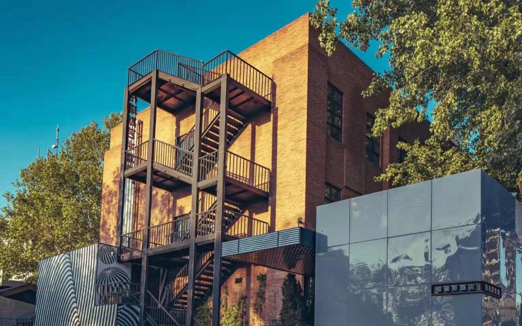 a building with a fire escape on the side of it at Gracie Art Hotel in Beijing