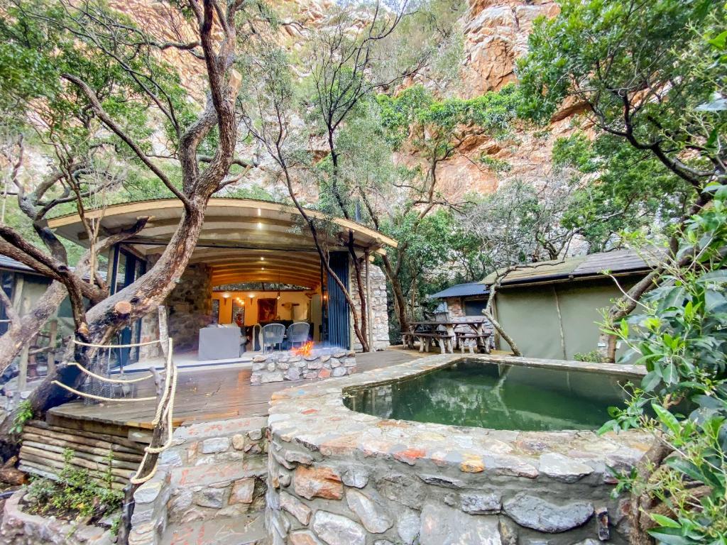 a house with a swimming pool in the woods at Kleinrivier Mountain Escapes in Uitenhage