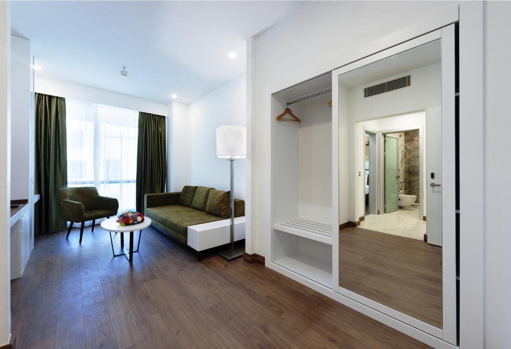 a living room with a mirror and a couch at ISG Sabiha Gökçen Airport Hotel in Istanbul