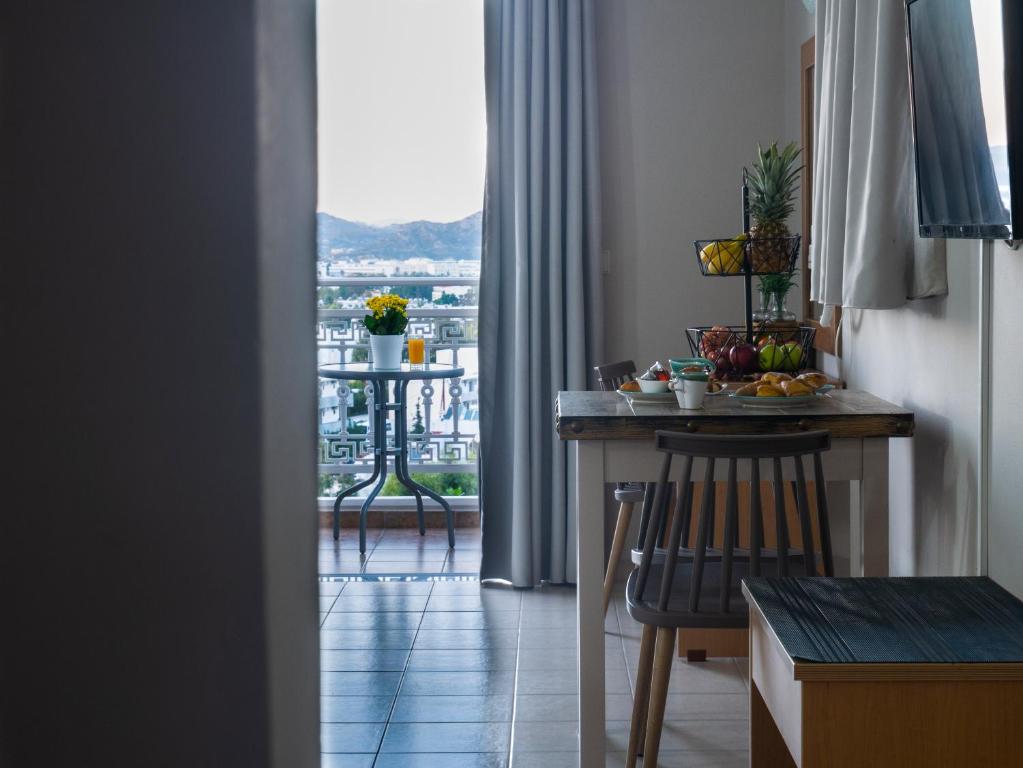 a kitchen with a table and a view of a balcony at Miva Sea View in Faliraki