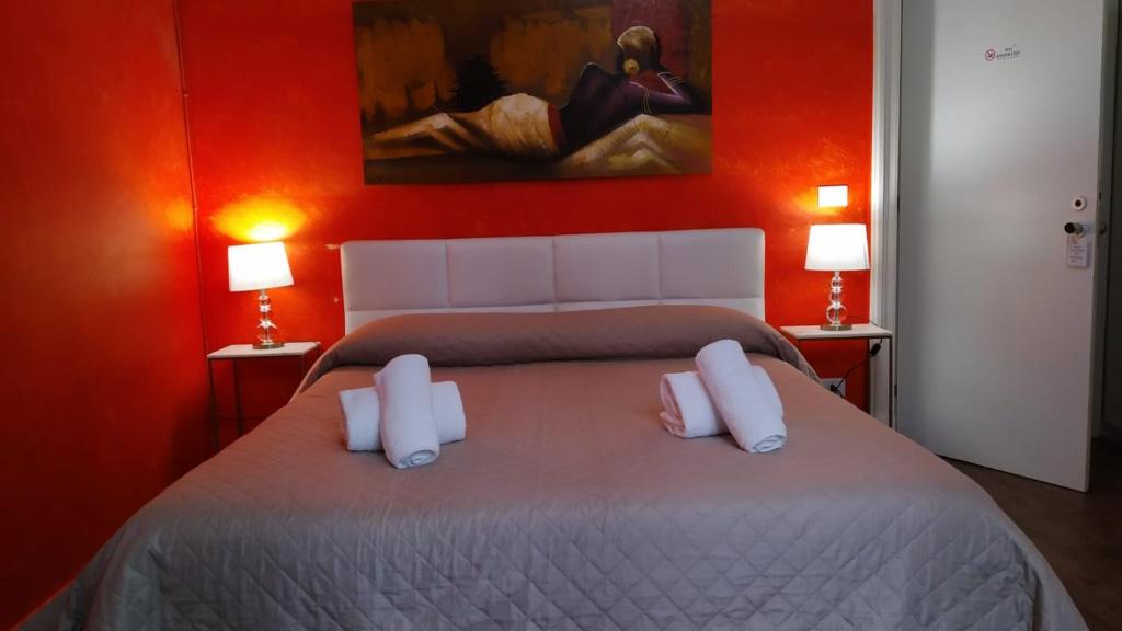 ein Schlafzimmer mit einem großen Bett mit zwei weißen Kissen in der Unterkunft CconfortHotels R&B Dolci Risvegli - SELF CHECK IN in Bari