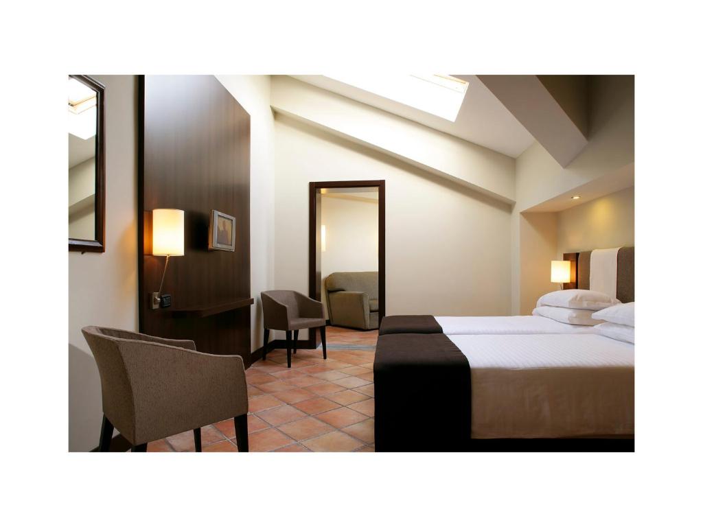 Postel nebo postele na pokoji v ubytování TH Roma - Carpegna Palace