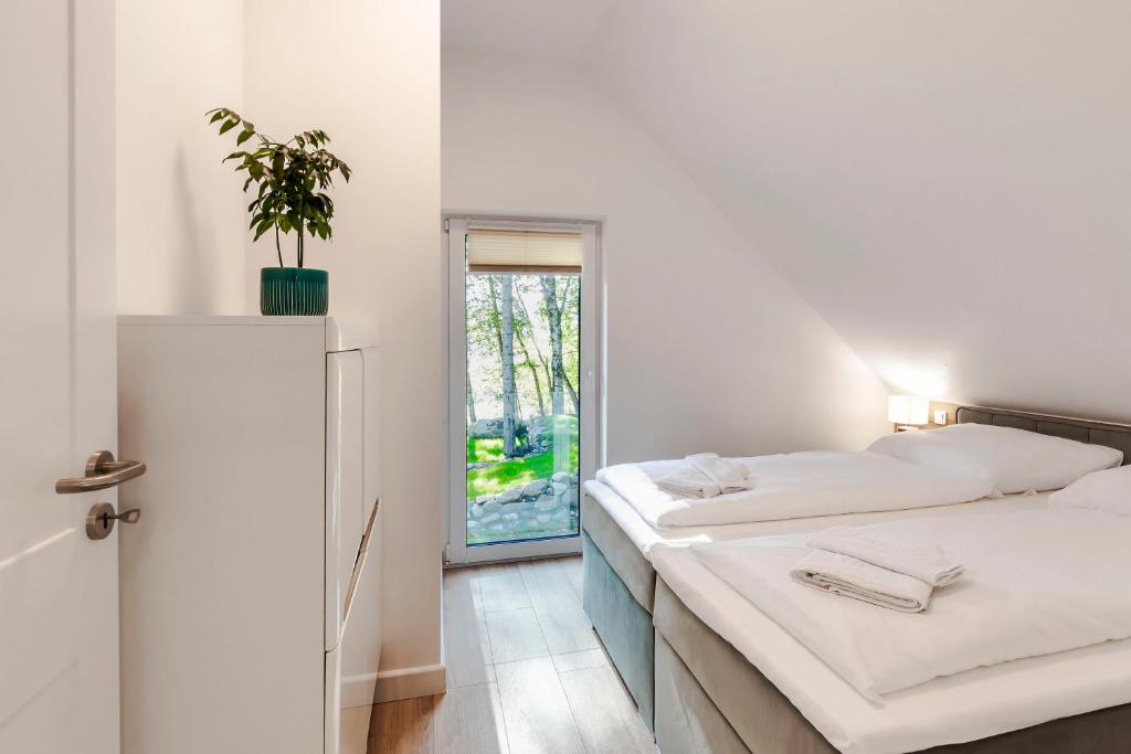Posteľ alebo postele v izbe v ubytovaní VacationClub – Szklarska Park VacationHome 2