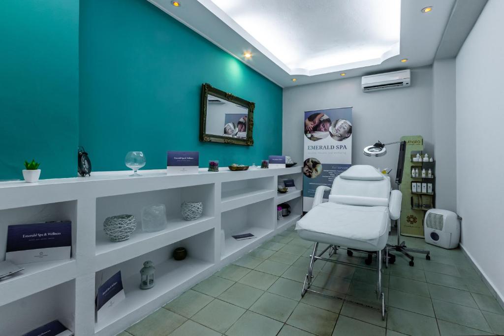 a salon with a white chair in a room at Skopelos Holidays Hotel & Spa in Skopelos Town