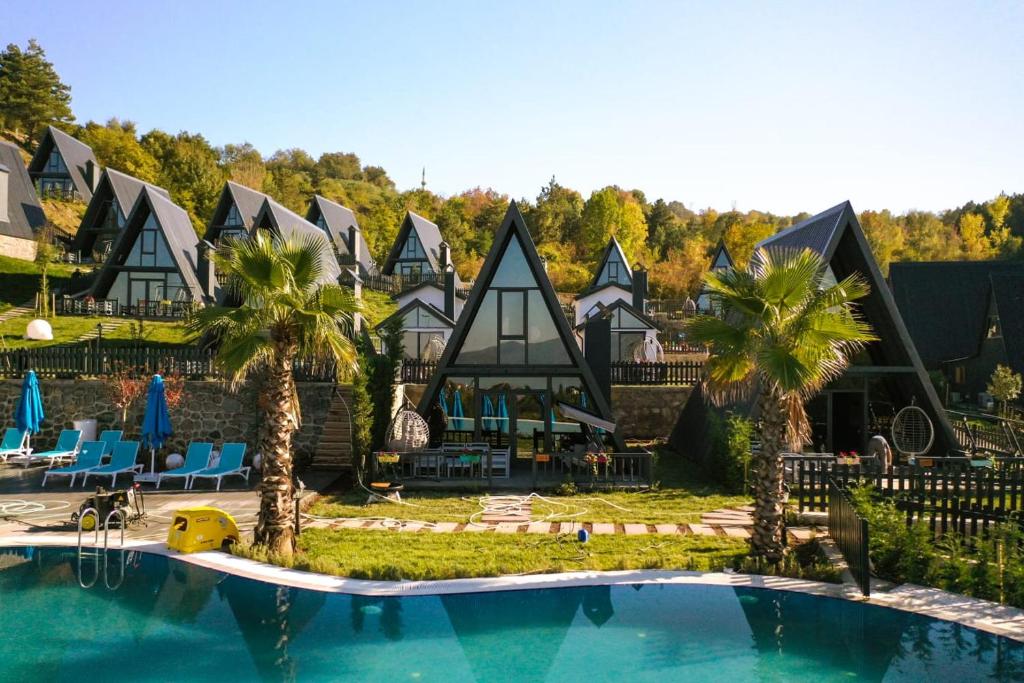 a resort with a pool and palm trees at World DREAMS Sapanca in Sakarya