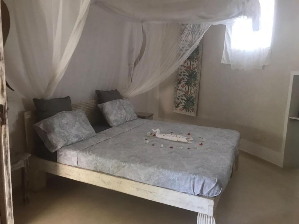 Postel nebo postele na pokoji v ubytování Watamu Shell House
