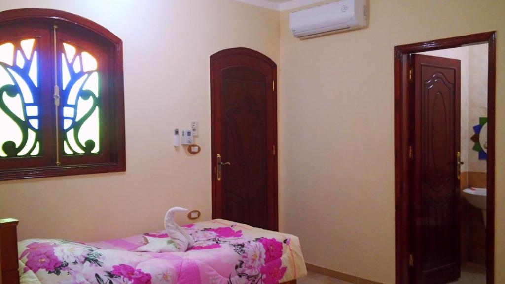 A bed or beds in a room at Pyramids Luxor Hotel & SPA