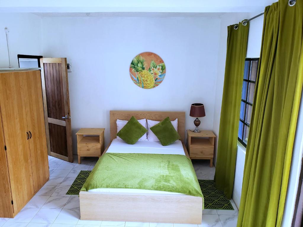 Rúm í herbergi á Bay View Studio Apartment 3B - Canouan Island