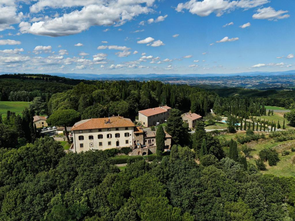 an aerial view of a building in the forest at Borgo Il Castagno in Gambassi Terme