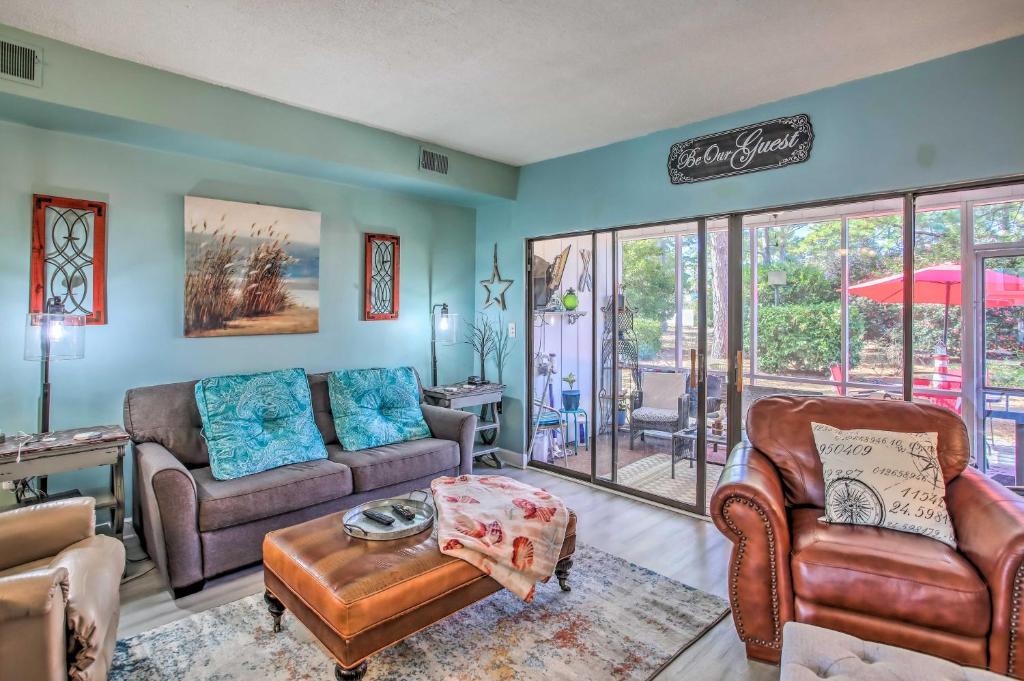 a living room with a couch and chairs and a table at Coastal Escape with Balcony and Grill Less Than 2 Mi to Beach! in Myrtle Beach