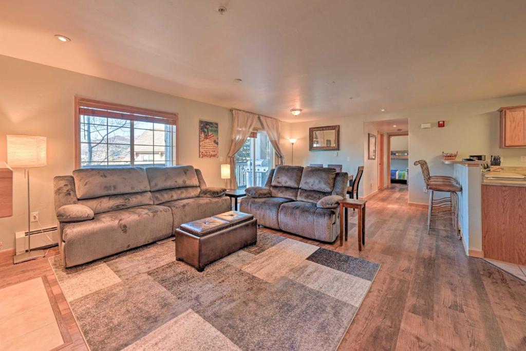a living room with a couch and a table at Steamboat Home with Garage, 1 Mi to Ski Resort in Steamboat Springs