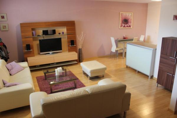een woonkamer met een bank en een tafel bij Holiday House - Orange Antik 112 Lipno Home in Lipno nad Vltavou