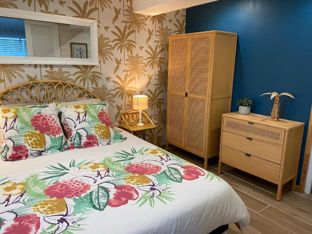 een slaapkamer met een bed en een dressoir bij La villa plein vent "La Bounty" gite 50m de la plage in Barneville-Carteret