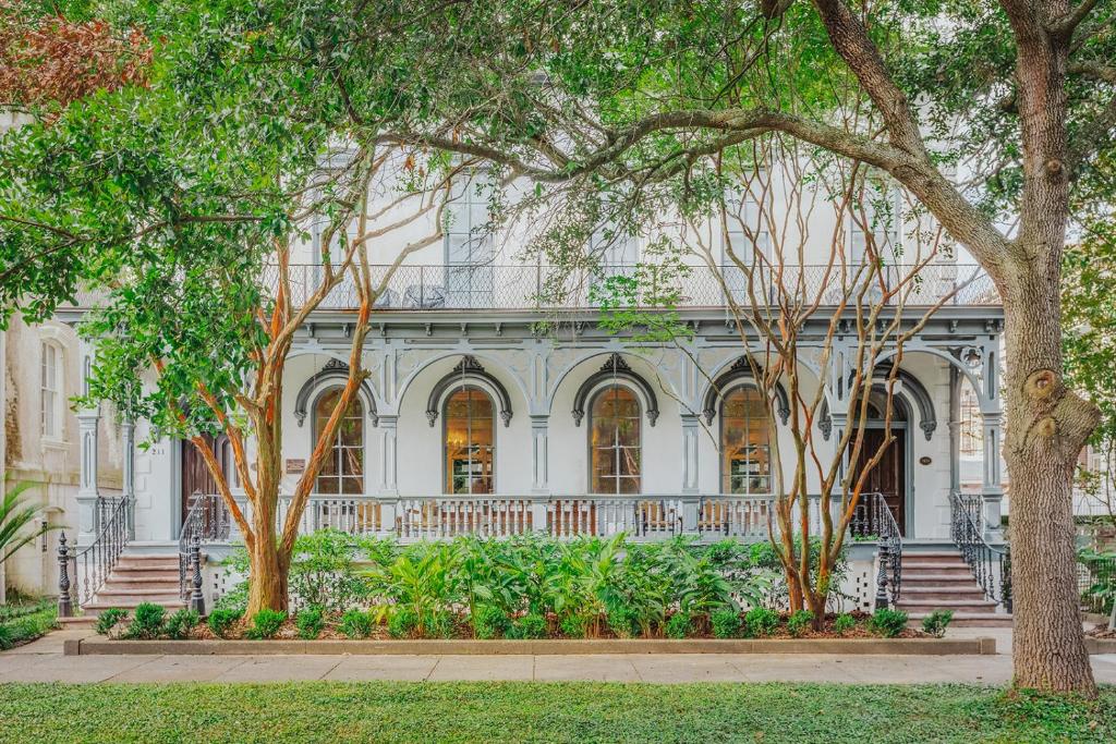 a white house with trees in front of it at Bellwether House in Savannah