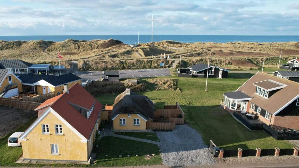 an aerial view of a house and the ocean at Fiskerhuset in Agger