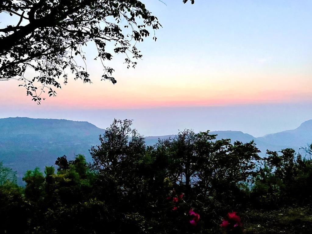 a view of the mountains with trees in the foreground at The Byke Retreat - Laxmi Resort - Pan India Pure Veg Hotel Chain in Matheran