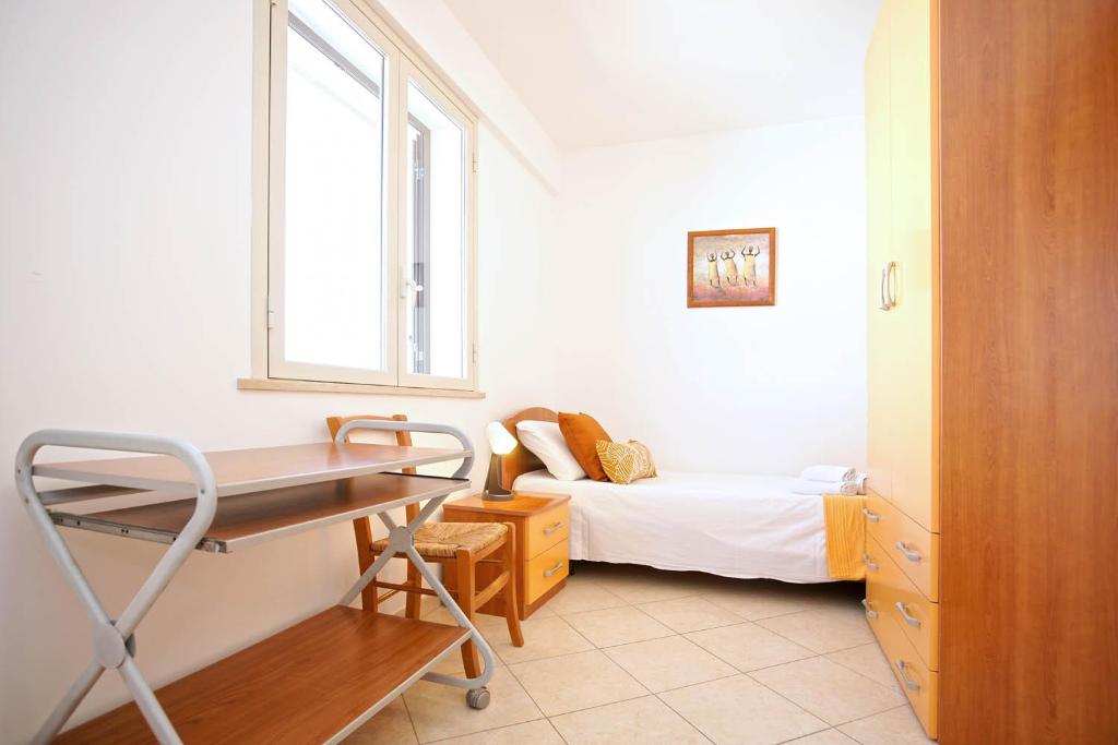 Posteľ alebo postele v izbe v ubytovaní CASA LUCA Appartamento al centro di Marzamemi vista mare con parcheggio privato