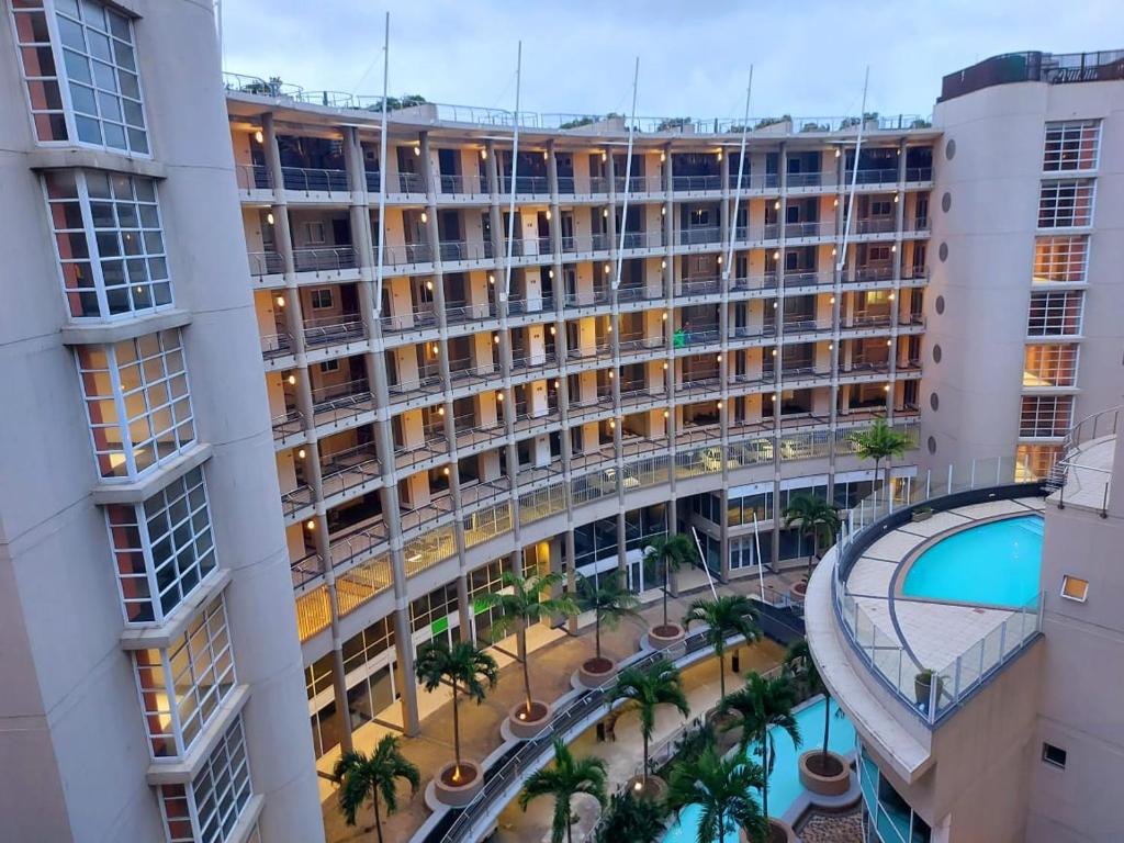 an overhead view of a large building with a courtyard at Ocean Sunrise at the Sails - Durban point waterfront in Durban